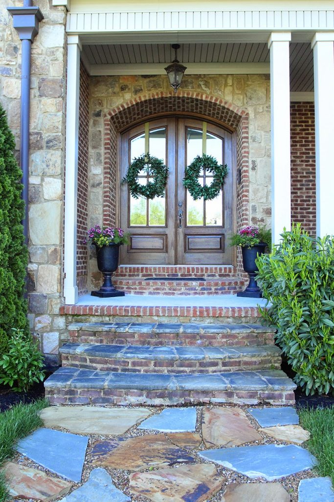 French country double entry doors give charming completions to the